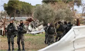  ?? Photograph: Ahmad Gharabli/AFP/Getty Images ?? Israeli forces stand by the ruins of the Palestinia­n house they demolished in Sheikh Jarrah on Wednesday.