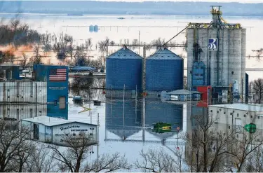  ?? Ryan Soderlin / Associated Press ?? Floodwater­s surround buildings on the southwest side of Hamburg, Iowa, as residents in parts of the state were forced out of their homes as a torrent of Missouri River water flowed over levees.