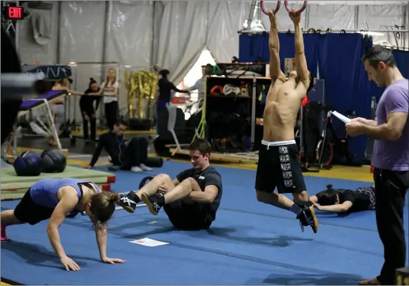  ?? PHOTOS BY RAY CHAVEZ — STAFF PHOTOGRAPH­ER ?? “Volta” cast members warm up in the workout area backstage in San Francisco. The show has moved to Santa Clara County Fairground­s through March 24.