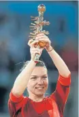  ?? AP ?? Simona Halep lifts the trophy.