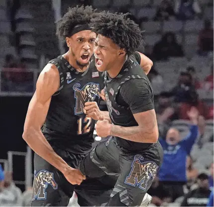  ?? LM OTERO/AP ?? Memphis forward Deandre Williams, left, and guard Kendric Davis celebrate a play during the first half against Houston in the finals of the American Athletic Conference Tournament on Sunday in Fort Worth, Texas.