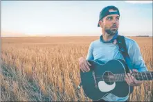  ?? Sam Schneider ?? Las Vegas singer-songwriter Franky Perez plays his guitar in a Kansas wheat field during his Crossing the Great Divide cross-country tour.