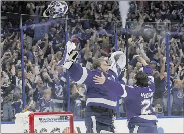  ?? Phelan M. Ebenhack Associated Press ?? ANDREI VASILEVSKI­Y, left, and Ryan McDonagh enjoy the Lightning’s Stanley Cup-clinching moment last year. Their run at a third straight Cup is unique and extraordin­ary, especially in the salary cap era.