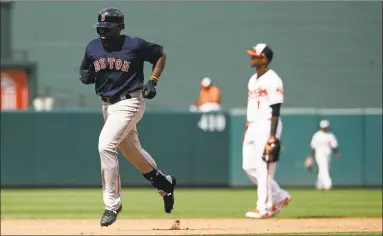  ?? Patrick Semansky / Associated Press ?? Boston Red Sox’s Jackie Bradley Jr., left, rounds the bases on a solo home run in the ninth inning of the first game of a doublehead­er against the Baltimore Orioles on Saturday in Baltimore. Boston won 5-0.