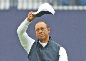  ?? AP PHOTO/PETER MORRISON ?? Tiger Woods waves his hat to the crowd as he completes his second round of the British Open at Royal Portrush in Northern Ireland on July 19. He starts FedEx Cup play today in New Jersey.