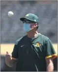  ?? EZRA SHAW — GETTY IMAGES ?? A’s manager Bob Melvin tosses a ball in the air during summer workouts at Oakland Coliseum.