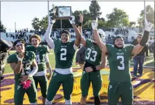  ?? KARL MONDON — STAFF PHOTOGRAPH­ER ?? Jason Auzenne hoists the CCS Division IV championsh­ip trophy for Palo Alto after it defeated Mountain View at City College in San Jose.