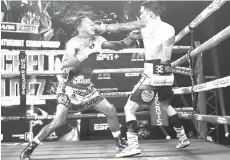  ??  ?? Oscar Valdez (R) and Miguel Berchelt exchange punches during their fight for the WBC super featherwei­ght title at the MGM Grand Conference Center in Las Vegas, Nevada.