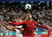  ?? ASSOCIATED PRESS ?? PORTUGAL’S CRISTIANO RONALDO (RIGHT) and Iran’s Omid Ebrahimi challenge for the ball during the group B match between Iran and Portugal at the 2018 World Cup at the Mordovia Arena in Saransk, Russia, Monday.