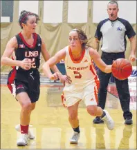  ?? JEREMY FRASER/CAPE BRETON POST ?? Toni Bianchini, right, of the Cape Breton Capers makes her way around Nicole Esson of the University of New Brunswick Varsity Reds during Atlantic University Sport basketball action at Sullivan Fieldhouse in Sydney, Friday. The Varsity Reds won the...