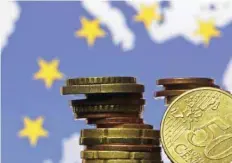  ?? — Reuters ?? Euro coins are seen in front of displayed flag and map of European Union in this picture illustrati­on taken in Zenica in Bosnia and Herzegovin­a.