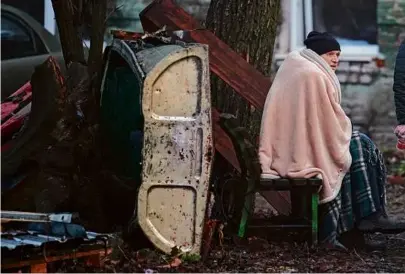  ?? VADIM GHIRDA/ASSOCIATED PRESS ?? A resident sat outside of an apartment block after Russian attacks in Kyiv, Ukraine, Thursday. Around 30 cruise and ballistic missiles were reported shot down over the capital.