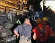  ?? COURTESY OF PAUL BARTLETT, EASTERN BERKS FIRE DEPARTMENT ?? Fire officials inspect the damage at a home on Woods Lane in Washington Township following a two-alarm fire Thursday night.