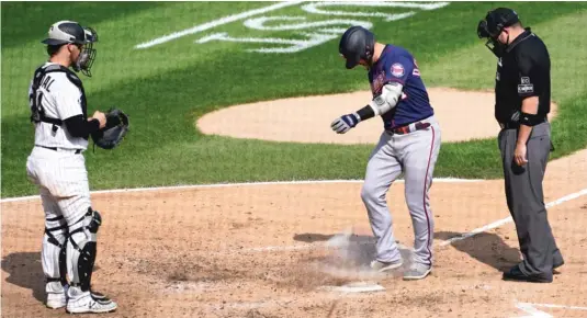  ?? AP ?? The Twins’ Josh Donaldson kicks dirt on home plate after his home run in the sixth inning Thursday, prompting umpire Dan Bellino to eject him from the game.