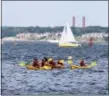  ?? JONATHAN TRESSLER — THE NEWS-HERALD ?? A group of paddlers navigate the waves just east of Fairport Harbor Lakefront Park in Lake Metroparks-rented kayaks.