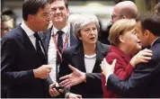  ?? ALASTAIR GRANT AP ?? British Prime Minister Theresa May, center, arrives at an EU summit in Brussels on Thursday. In the two-day meeting, EU leaders will focus on the Brexit negotiatio­ns.