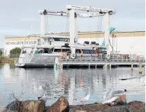  ??  ?? A travel lift hauls the Circa Marine 24m expedition motor launch Mollymawk into the water at Port Nikau.