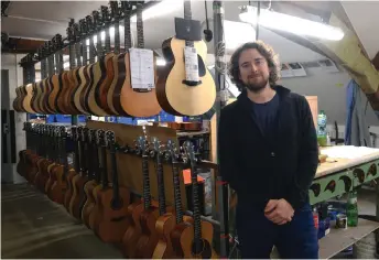  ?? — AFP photo ?? Furch poses with their guitars on March 11 in their manufactor­y in Velke Nemcice, Czech Republic.