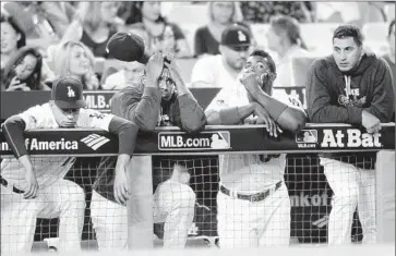  ?? Wally Skalij Los Angeles Times ?? THE DODGERS DIDN’T ENJOY the view from the dugout, as they struggled to get anything going against Mets pitching in Game 1. They didn’t score until Adrian Gonzalez’s RBI single in the eighth inning.