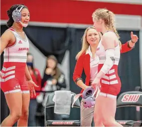  ?? Sacred Heart Athletics/Contribute­d Photo ?? Sacred Heart University women’s wrestling coach Paulina Biega congratula­tes Madison Sandquist after a match.