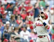  ?? NICK WASS — THE ASSOCIATED PRESS ?? Philadelph­ia Phillies’ Carlos Santana celebrates his home run during the eighth inning of a baseball game against the Washington Nationals Saturday in Washington. The Phillies won 5-3.