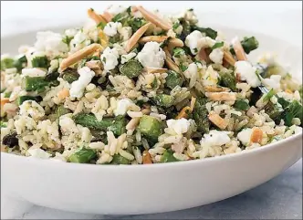  ?? The Associated Press ?? This photo provided by America's Test Kitchen in August 2018 shows a brown rice salad with asparagus and goat cheese in Brookline, Mass. This recipe appears in the cookbook "Holiday Entertaini­ng."