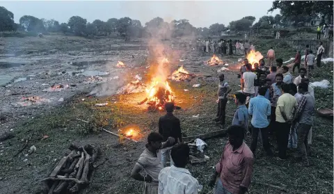  ?? AFP ?? Cremations taking place at a mass funeral of some 20 people who were killed in a powerful explosion at Petlawad town, in Jabua district of central Madhya Pradesh state, on Saturday. Police fear as many as 100 may have died when illegally stored...