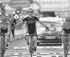  ?? AP ?? Britain’s Simon Yates, center, celebrates as he crosses the finish line ahead of Austria’s Gregor Muhlberger, left, and Spain’s Pello Bilbao Lopez De Armentia on Thursday in Bagneres-de-bigorre, France.