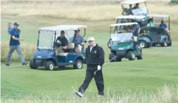  ?? — AFP ?? President Donald Trump walks as he plays a round of golf on the Ailsa course at Trump Turnberry, the luxury golf resort of President Donald Trump, in Turnberry, Scotland, on Saturday.