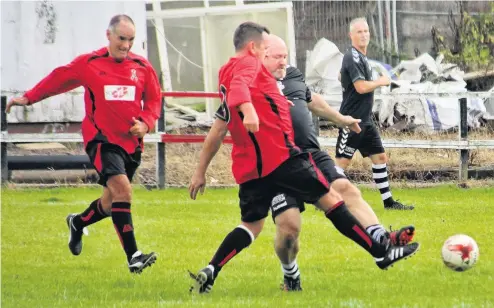  ??  ?? Midfield battle Tommy Sheridan, left, comes charging in trying to break up play