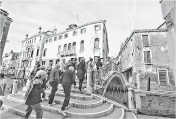  ?? PHOTOS BY GENE SLOAN/USA TODAY ?? Passengers from Uniworld's River Countess are led on a guided tour through Venice. Afterward, the group will board a water taxi back to their “hotel,” a small river ship tied up along a nearby waterway.