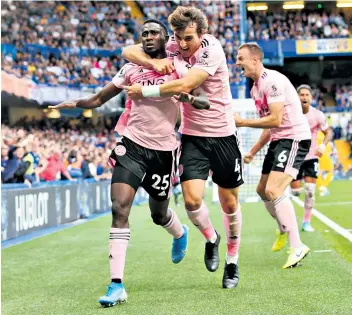  ??  ?? Danger men: Wilfred Ndidi (left) celebrates scoring at Chelsea in a performanc­e that suggested Leicester will be a force to be reckoned with this season