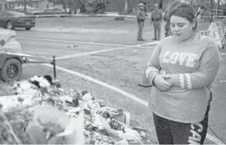  ?? Marie D. De Jesús / Houston Chronicle ?? Alison Gould, 17, visits the memorial that members of the community in Sutherland Springs prepared to honor the 26 people who were killed Sunday at First Baptist Church.