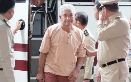  ?? PORNCHAI KITTIWONGS­AKUL/AFP ?? Lieutenant General Manas Kongpan, now convicted of involvemen­t in human traffickin­g, arrives at a court in Bangkok in 2015.