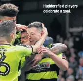  ??  ?? Huddersfie­ld players celebrate a goal.