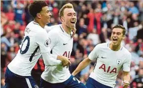  ?? EPA PIC ?? Tottenham's Christian Eriksen (centre) celebrates with teammates after scoring against Bournemout­h on Saturday.