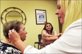  ?? PETER HVIZDAK — NEW HAVEN REGISTER ?? Loretta D’Aniello, 91 of West Haven, left, is fitted for a Beltone BTE hearing aid by Nicole Starinovic­h, a licensed hearing care practition­er, right, at the Beltone Hearing Center in Orange Tuesday as D’Aniello’s granddaugh­ter, Melissa D’Aniello,...