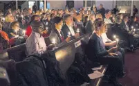  ?? CHRISTOPHE­R KATSAROV/THE CANADIAN PRESS FILE PHOTO ?? Mourners hold candles during a vigil after the deaths of several men in the LGBTQ community by an alleged serial killer.