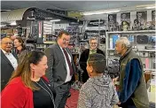  ??  ?? Finance Minister Grant Robertson, centre, and King Sound Centre owner Paul King, third from right, talk post-lockdown business.