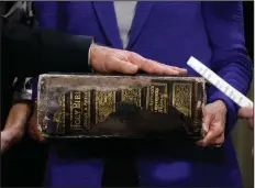  ?? (AP/Carolyn Kaster) ?? Vice President Joe Biden (left) places his hand on the Biden family Bible held by his wife, Jill Biden (center), as he takes the oath of office from Supreme Court Justice Sonia Sotomayor (right) during an official ceremony at the Naval Observator­y in Washington. While many presidents have used Bibles for their inaugurati­ons, the Constituti­on does not require the use of a specific text and specifies only the wording of president’s oath. That wording also doesn’t include the phrase “so help me God,” but every modern president has appended it to their oaths and most have chosen symbolical­ly resonant Bibles for their inaugurati­ons.