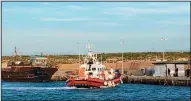  ?? AP/ELIO DESIDERIO ?? This photo taken on Friday and made available Monday shows the arrival of a Coast Guard boat carrying 18 migrants at the port of the Sicilian island of Lampedusa, southern Italy.