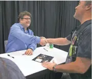  ?? DAVID WALLACE/THE REPUBLIC ?? Sean Astin shakes hands with Richard Cornwell, of Phoenix, while Astin was signing autographs at Phoenix Comicon at the Convention Center last year.