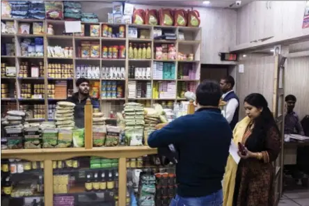  ?? UDIT KULSHRESTH­A — BLOOMBERG ?? Customers browse a Patanjali Ayurved store in New Delhi, India.