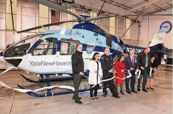  ?? ?? Medical staff and helicopter crew cut a ribbon during an unveiling ceremony for the second SkyHealth helicopter in the Three Wing Aviation hangar at Sikorsky Memorial Airport, in Stratford, Feb. 9.