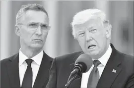  ?? Geert Vanden Wijngaert Associated Press ?? PRESIDENT TRUMP, with NATO Secretary-General Jens Stoltenber­g, stopped short of reaffirmin­g the alliance’s mutual defense pledge in his remarks.