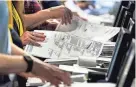  ?? GENE J. PUSKAR/AP FILE ?? Election workers recount ballots from the Pennsylvan­ia primary election on June 1, 2022, in Pittsburgh. Election officials note that there have been thousands of threats nationwide yet relatively few prosecutio­ns.