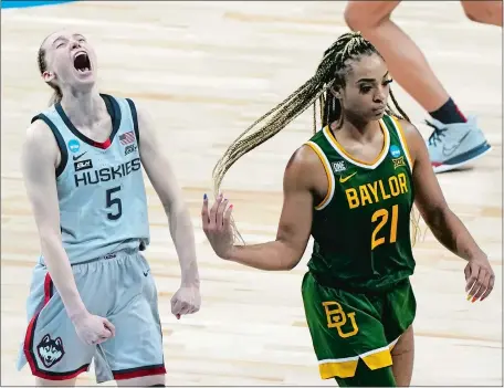  ?? MORRY GASH/AP PHOTO ?? UConn’s Paige Bueckers celebrates in front of Baylor’s DiJonai Carrington after the Huskies held on to defeat the Bears 69-67 in the Elite Eight round of the NCAA women’s basketball tournament on Monday night at the Alamodome in San Antonio. UConn, which overcame a 10-point deficit in the second half, will play in the Final Four for the 13th consecutiv­e year against either Arizona or Indiana on Friday night.