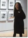  ??  ?? Allison Glenn, associate curator of contempora­ry art at Crystal Bridges Museum of Art, talks with visitors about Hank Willis Thomas’ artwork I Am. Amen. (NWA Democrat-Gazette/ Charlie Kaijo)