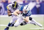  ?? Andy Lyons Getty Images ?? JACK DOYLE of the Indianapol­is Colts is tackled by Pittsburgh Steeler Ryan Shazier on Thanksgivi­ng.