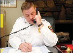  ?? SAMANTHA BAKER NORTHWEST ARKANSAS NEWSPAPERS ?? Harley Hunt, battalion chief and fire marshal for Fayettevil­le, answers a phone call Friday at his office on North Crossover Road. Hunt, originally from Farmington, has been with the Fayettevil­le Fire Department for 14 years.